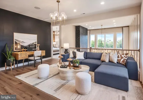 a living room with furniture chandelier and a large window
