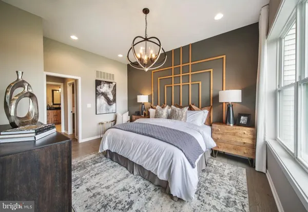 a bedroom with bed and a chandelier