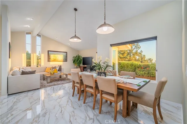 a dining room with furniture and a large window
