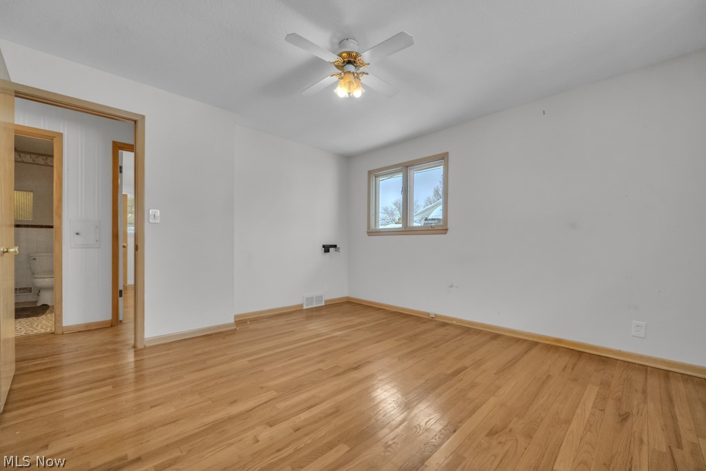 6846 Revere Road Cleveland, OH 44130 - Photo 21 of 30 Empty room featuring a ceiling fan and light wood-style floors