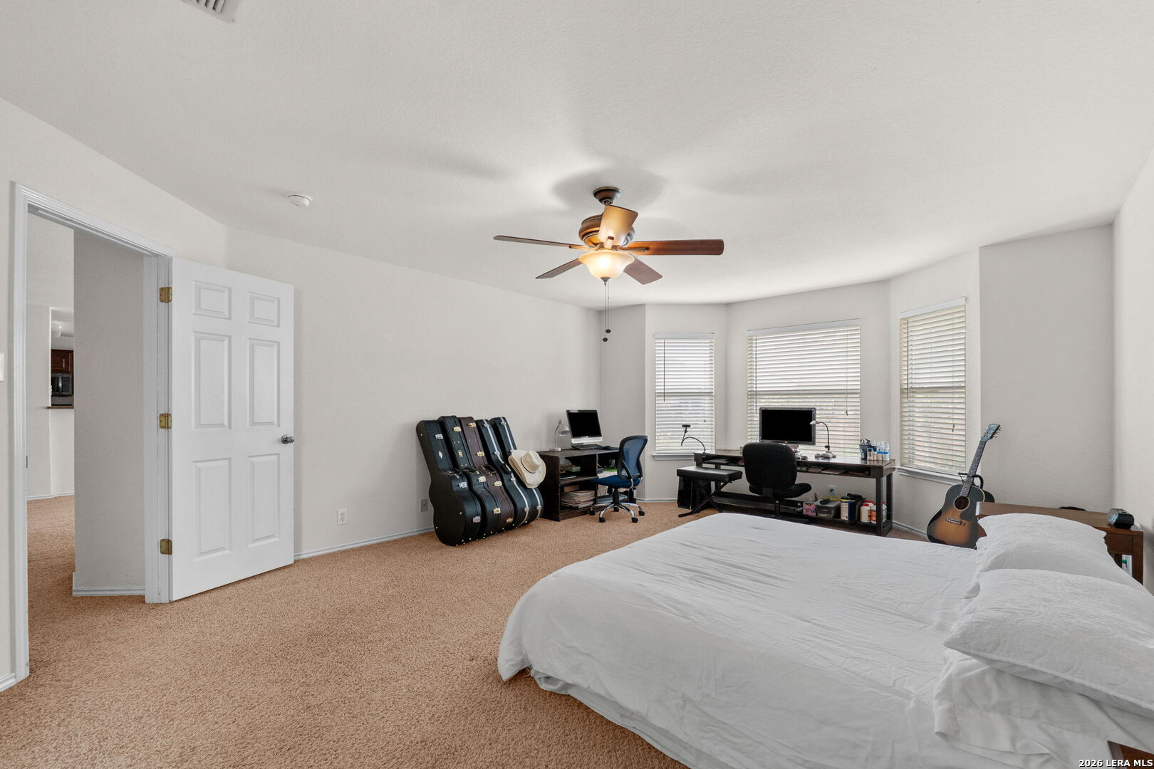 9727 Krier Court Converse, TX 78109 - Photo 12 of 31 a bedroom with a bed and a chandelier