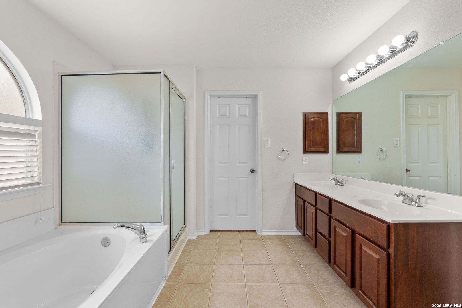 9727 Krier Court Converse, TX 78109 - Photo 13 of 31 a bathroom with a tub a sink and a large mirror
