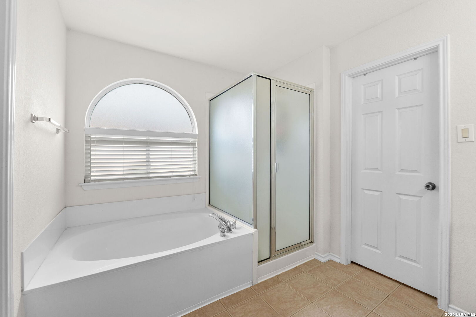 9727 Krier Court Converse, TX 78109 - Photo 14 of 31 a bathroom with a bathtub and a shower