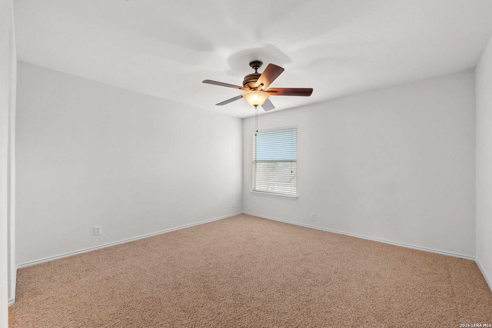 9727 Krier Court Converse, TX 78109 - Photo 16 of 31 a view of a room with a ceiling fan and a window