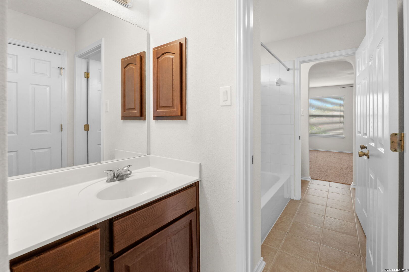 9727 Krier Court Converse, TX 78109 - Photo 17 of 31 a bathroom with a sink mirror and shower