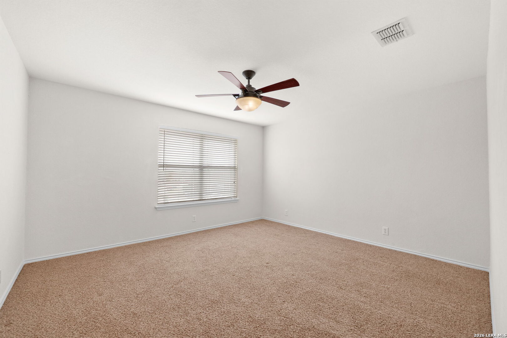 9727 Krier Court Converse, TX 78109 - Photo 19 of 31 an empty room with chandelier fan and windows