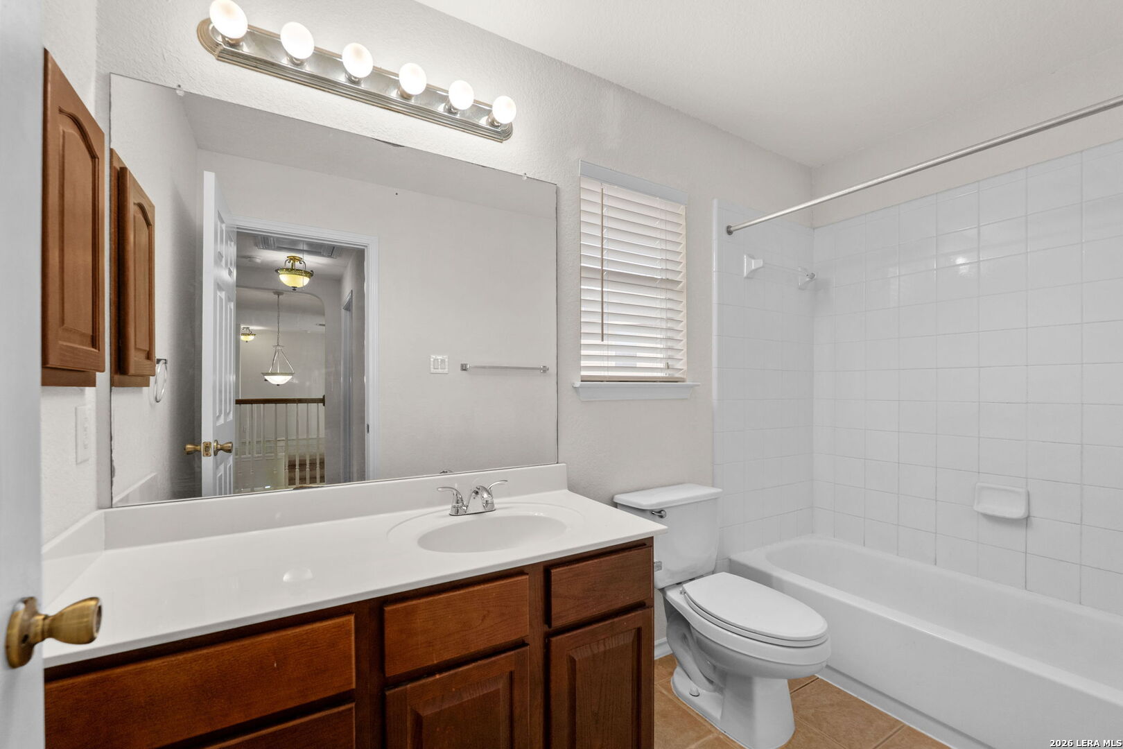 9727 Krier Court Converse, TX 78109 - Photo 20 of 31 a bathroom with a sink a toilet a mirror and shower