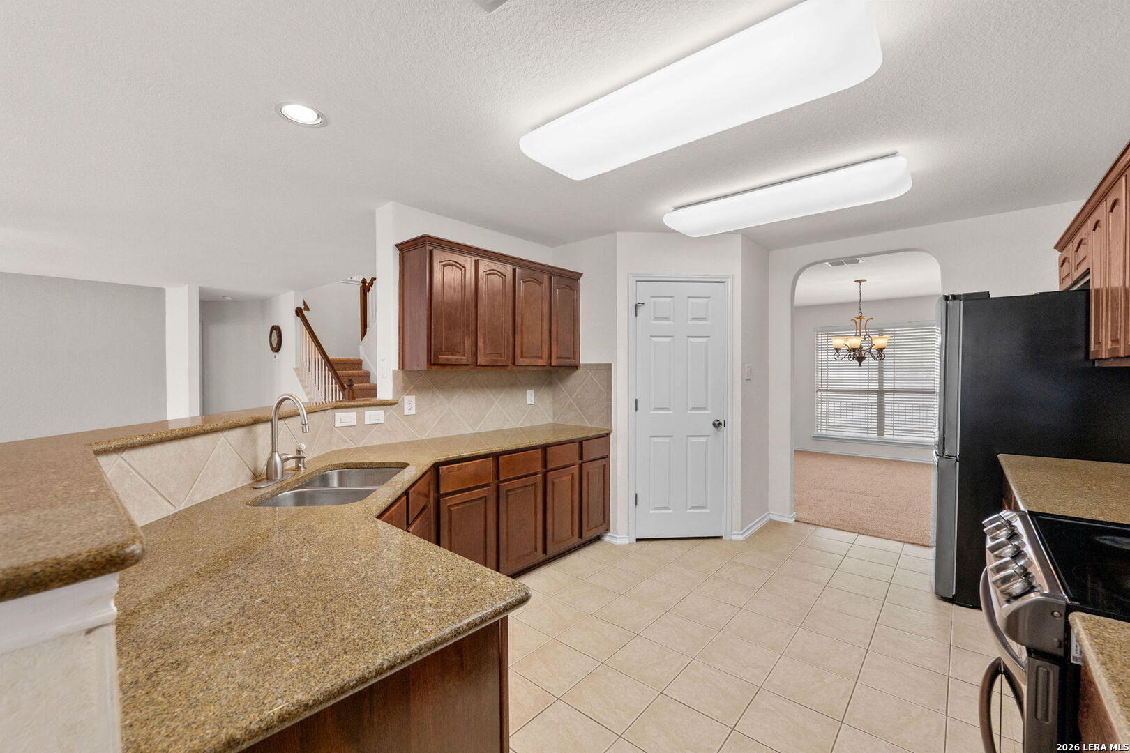 9727 Krier Court Converse, TX 78109 - Photo 7 of 31 a kitchen with stainless steel appliances granite countertop a sink and cabinets