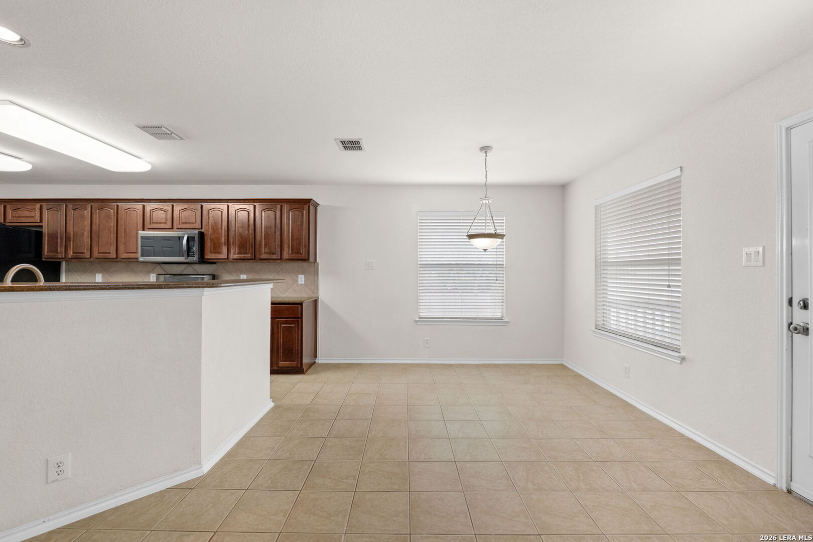 9727 Krier Court Converse, TX 78109 - Photo 8 of 31 a kitchen with stainless steel appliances granite countertop a sink and cabinets