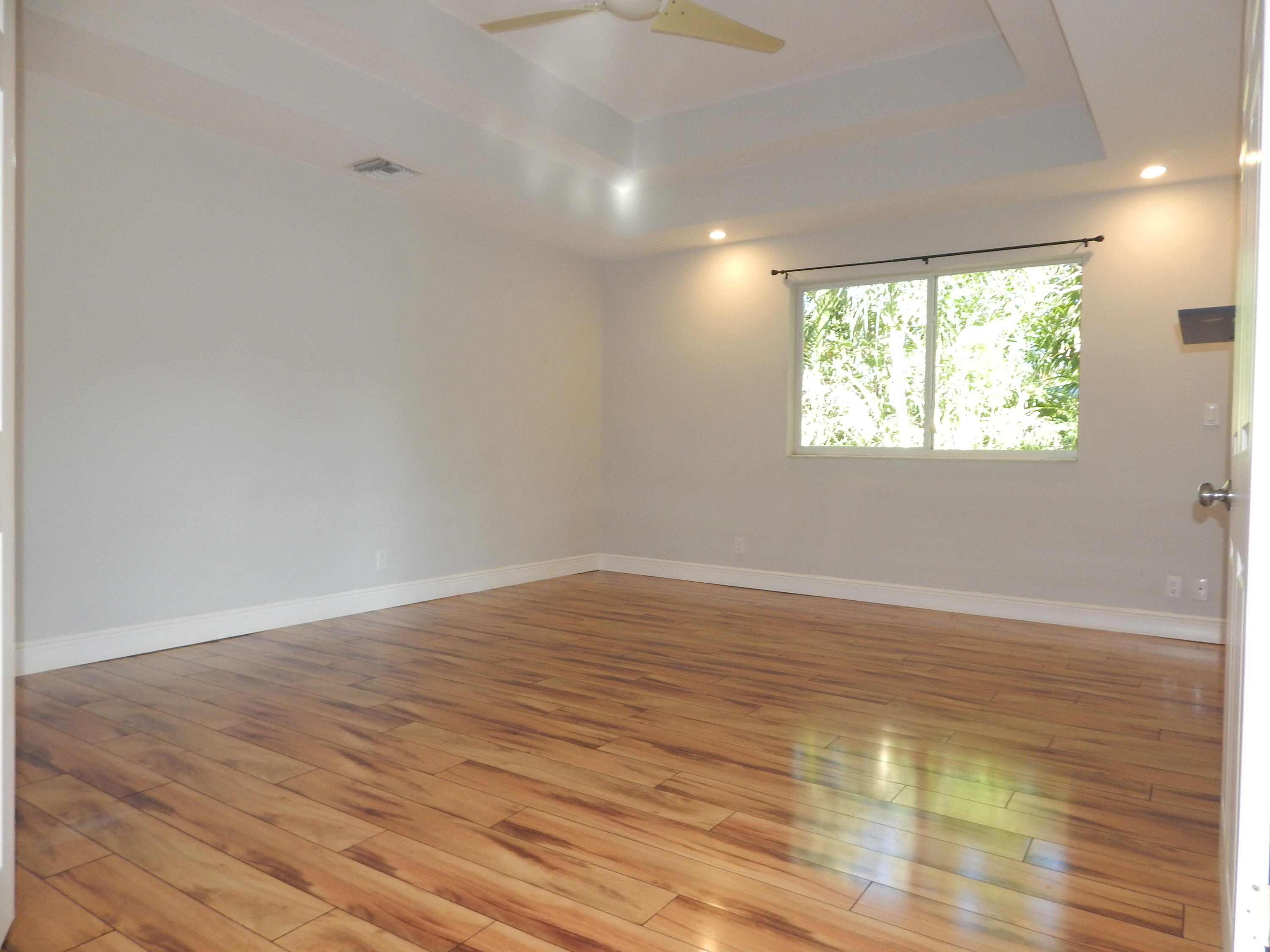 298 Northwest 11th Street Boca Raton, FL 33432 - Photo 11 of 19 an empty room with wooden floor and windows
