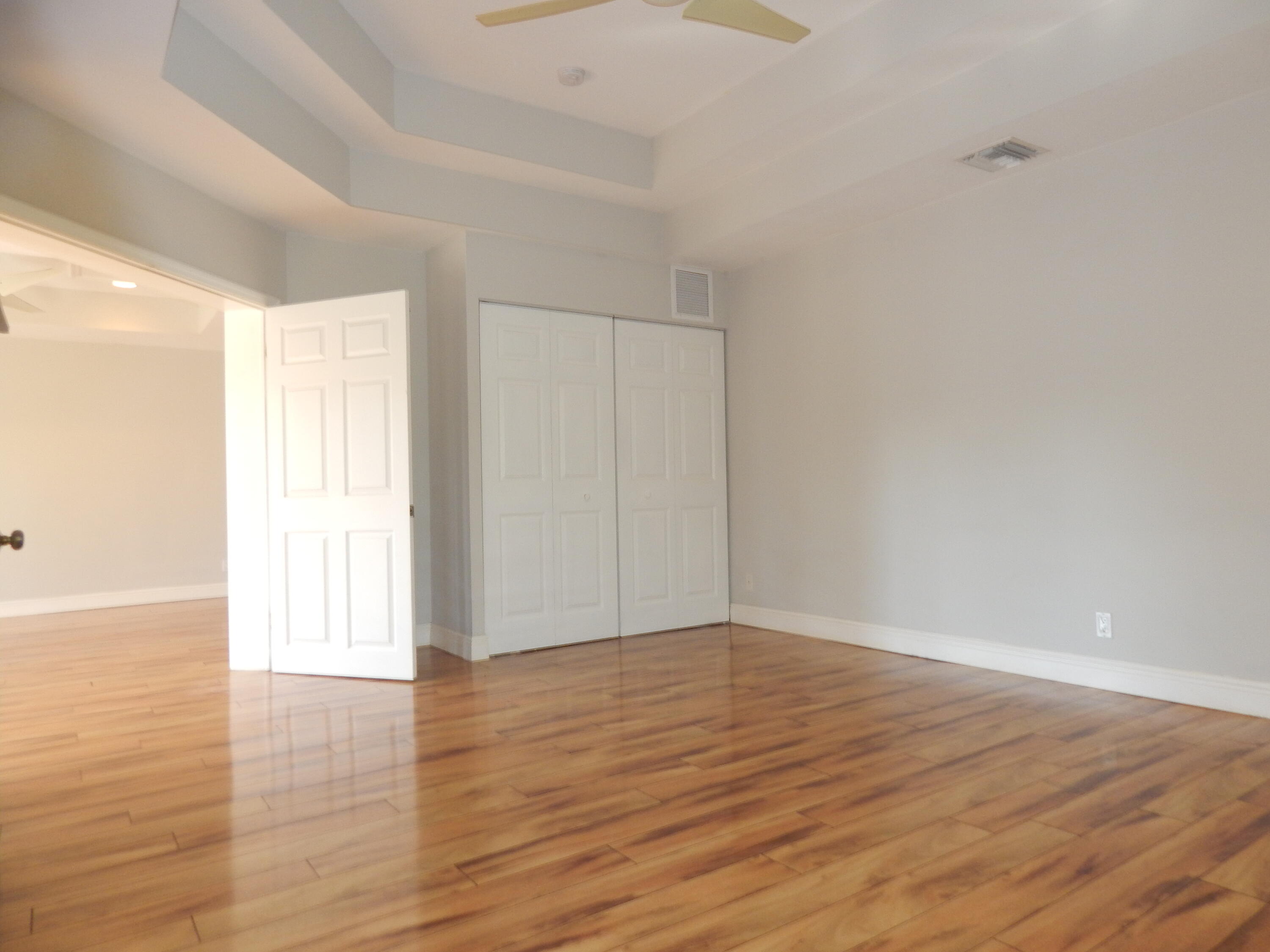 298 Northwest 11th Street Boca Raton, FL 33432 - Photo 12 of 19 a view of an empty room with wooden floor and a window