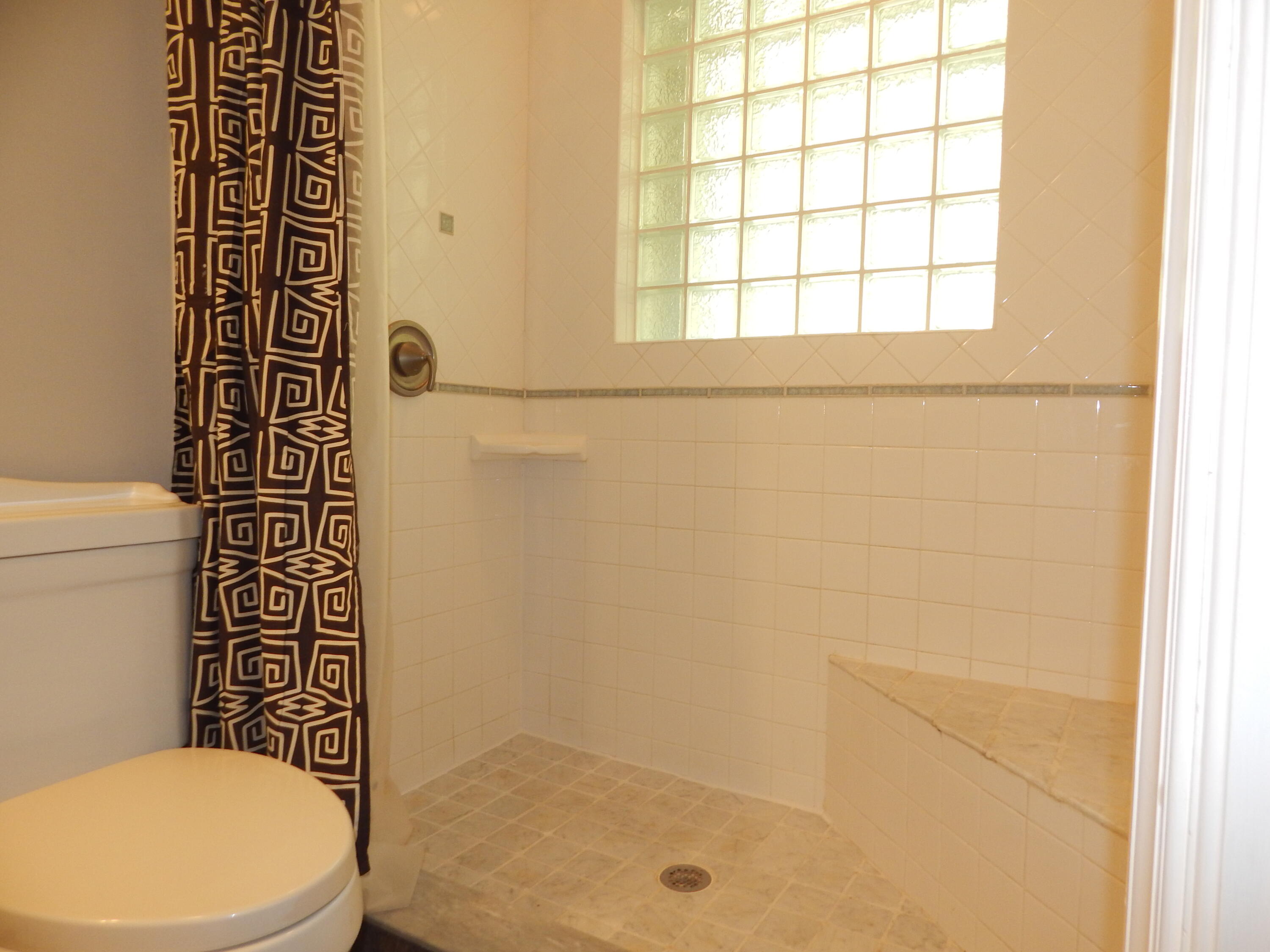 298 Northwest 11th Street Boca Raton, FL 33432 - Photo 16 of 19 a bathroom with a toilet and a shower