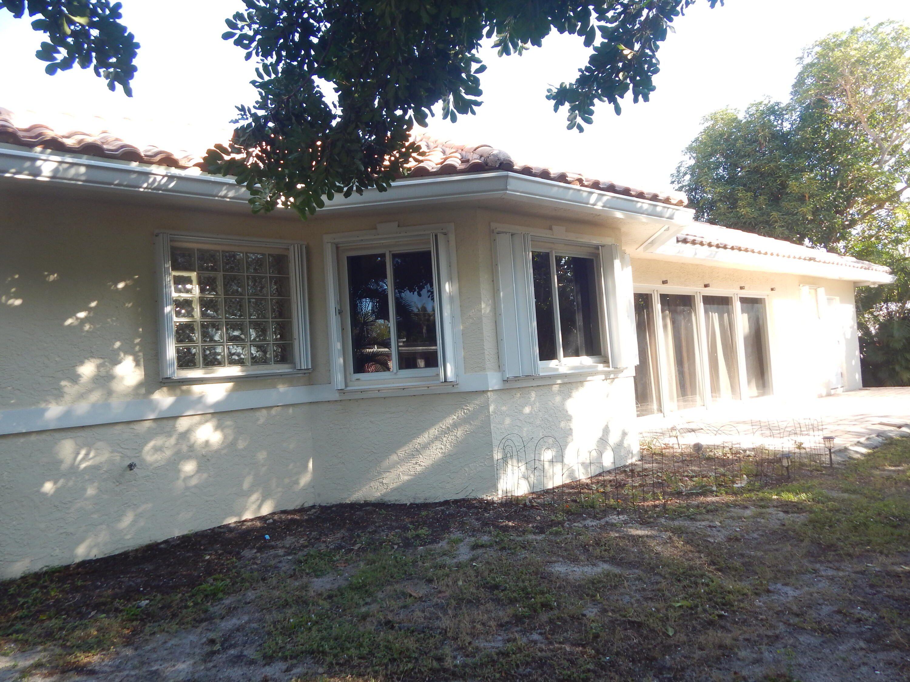 298 Northwest 11th Street Boca Raton, FL 33432 - Photo 2 of 3 a view of a house with a small yard