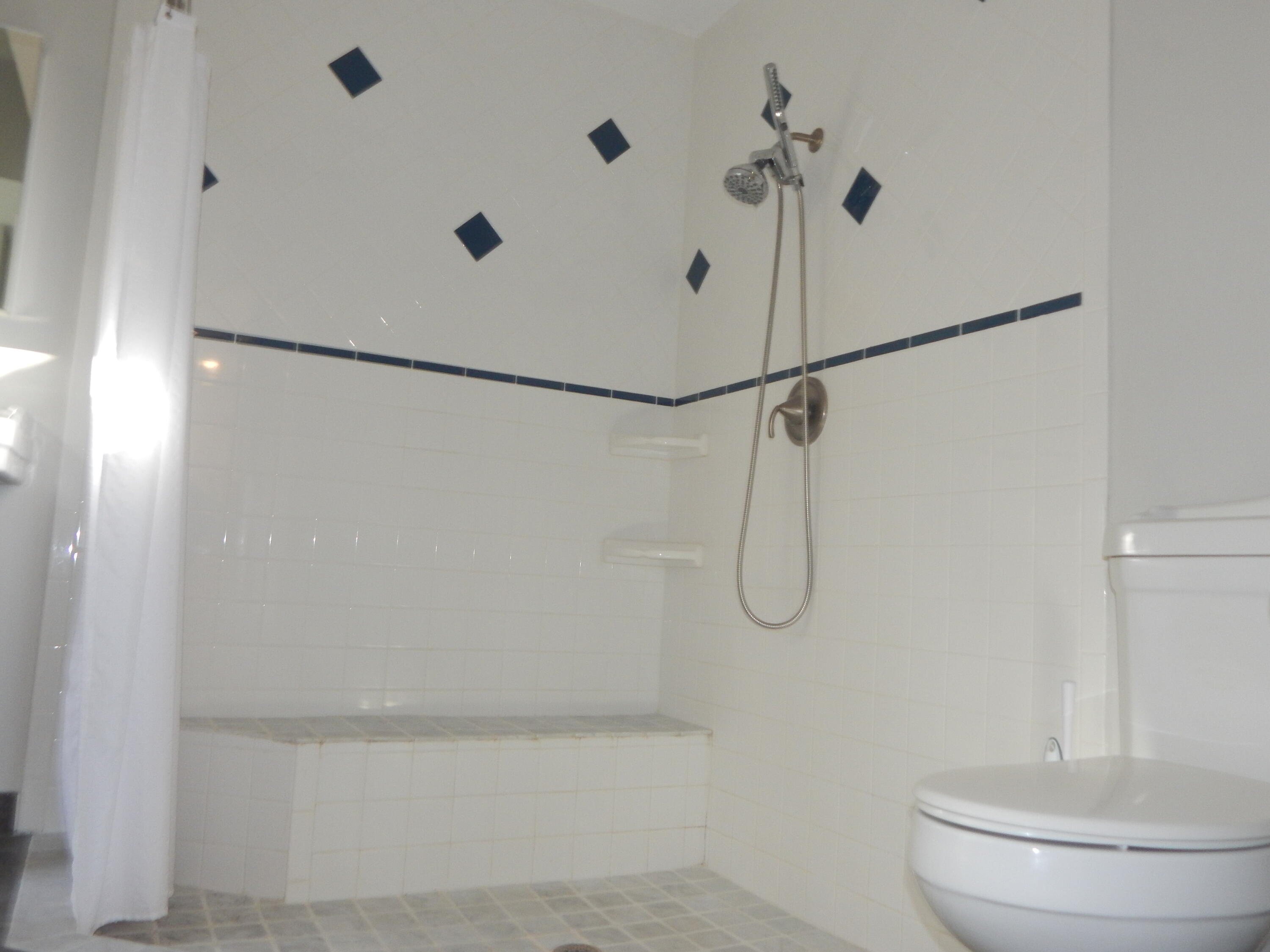 298 Northwest 11th Street Boca Raton, FL 33432 - Photo 8 of 19 a bathroom with a glass shower door