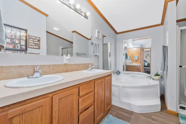 a spacious bathroom with a granite countertop sink and a mirror