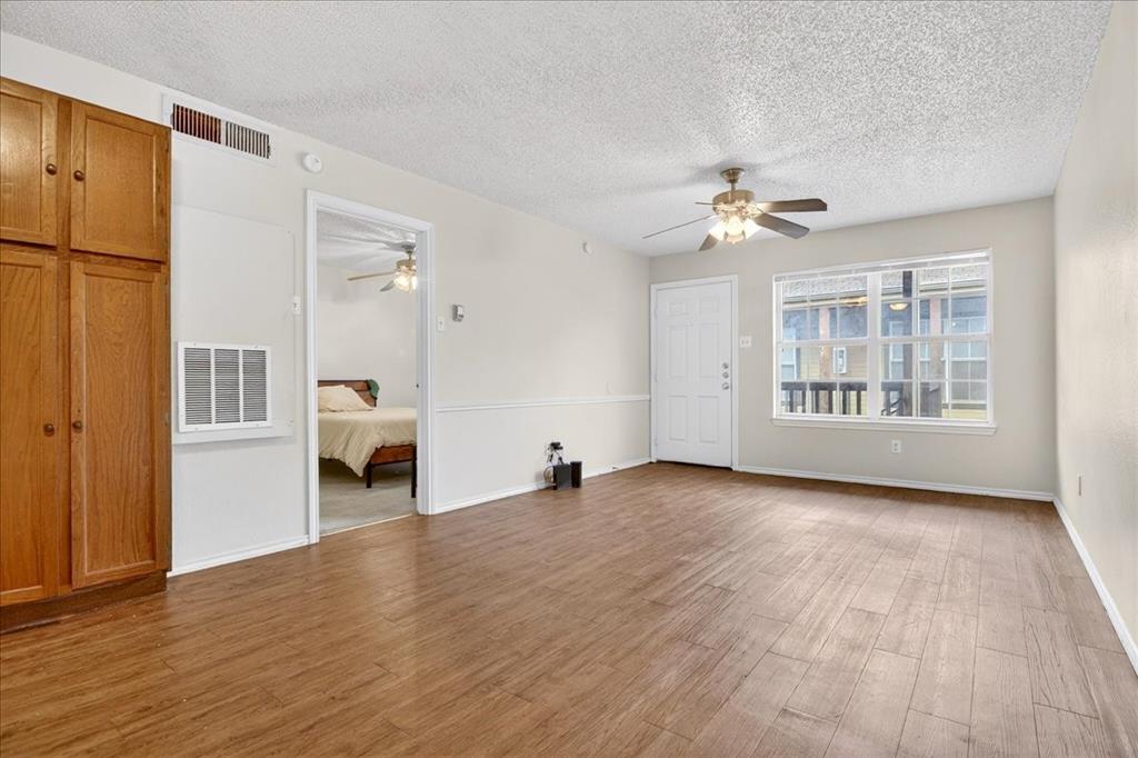 1326 South 11th Street, Unit 2 Waco, TX 76706 - Photo 4 of 11 a view of an empty room with a window and wooden floor