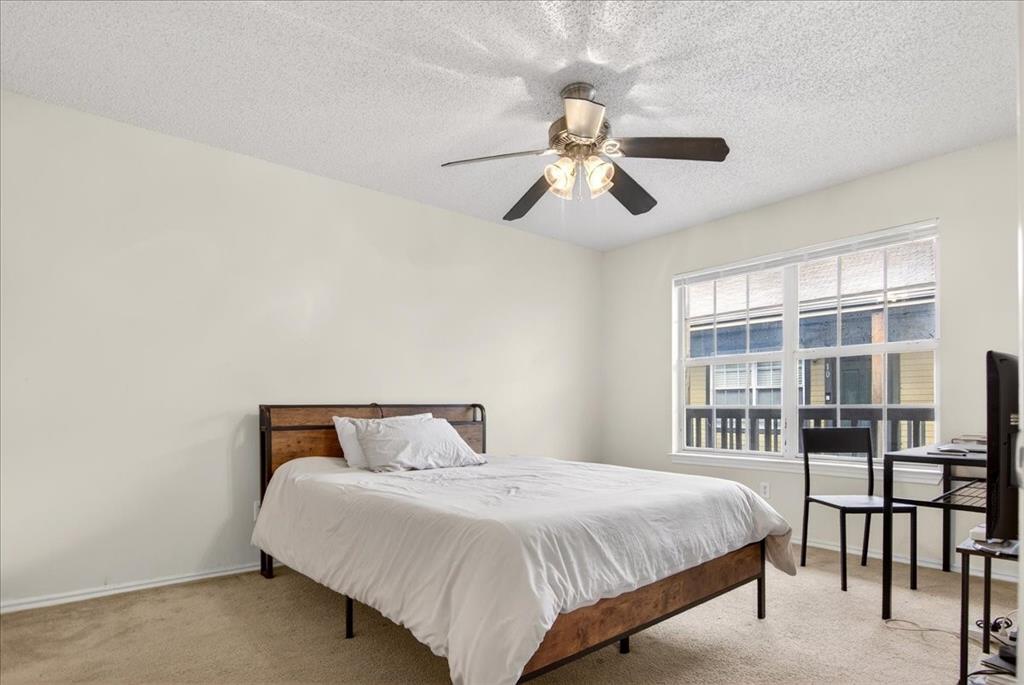 1326 South 11th Street, Unit 2 Waco, TX 76706 - Photo 5 of 11 a bedroom with a bed and a large window