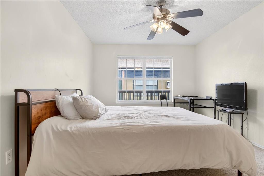 1326 South 11th Street, Unit 2 Waco, TX 76706 - Photo 6 of 11 a bedroom with a large bed and a tv