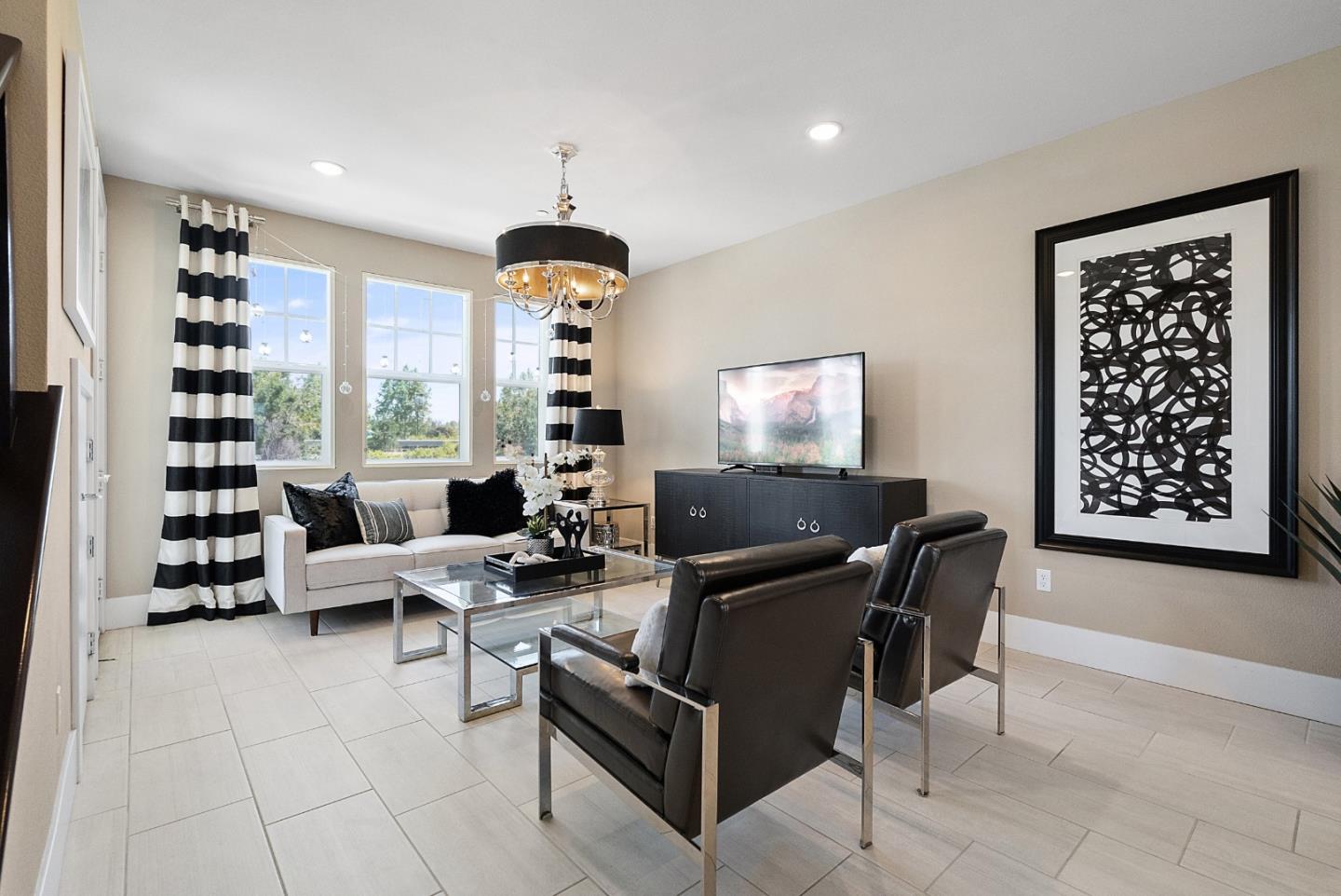 a living room with furniture a piano and a flat screen tv