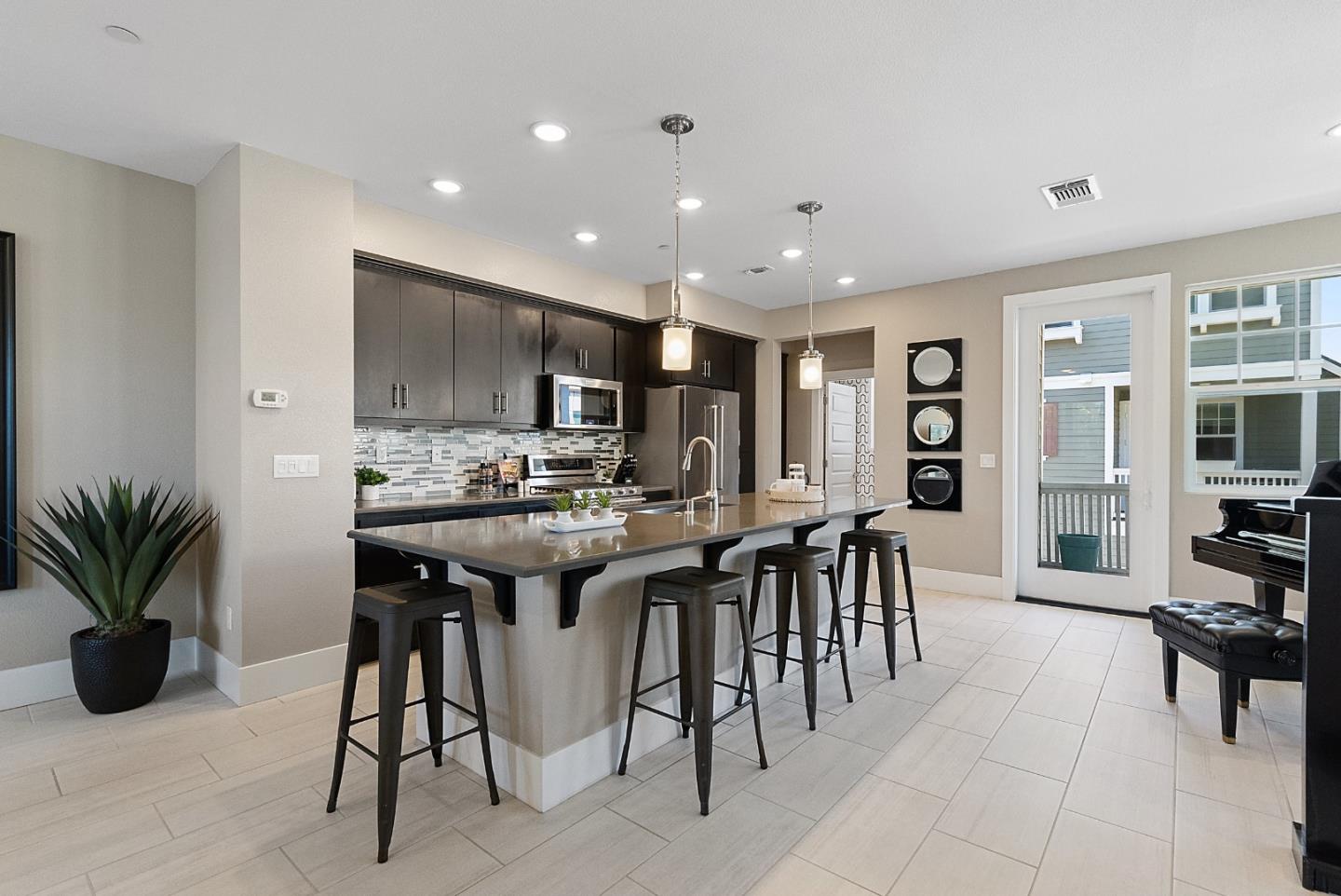 398 Circuit Way Mountain View, CA 94043 - Photo 11 of 29 a kitchen with stainless steel appliances kitchen island granite countertop a table chairs sink and cabinets
