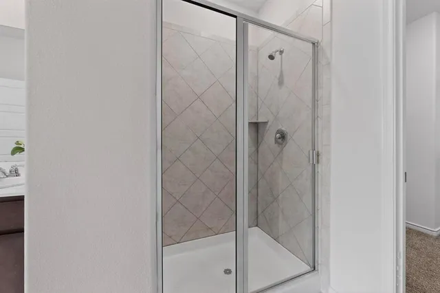a bathroom with a glass shower door