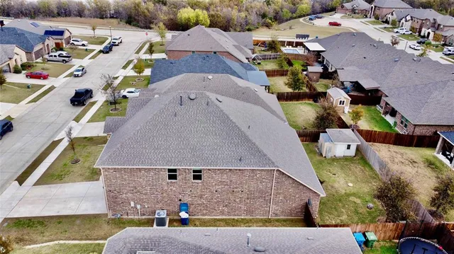 an aerial view of a house with a swimming pool