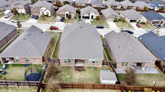 an aerial view of a house with a swimming pool
