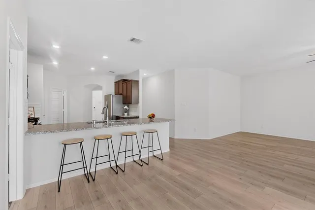 a view of kitchen with cabinets and wooden floor