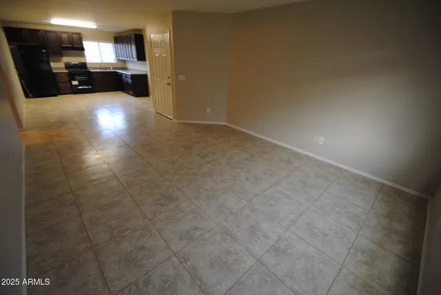 a view of kitchen with kitchen island and stainless steel appliances