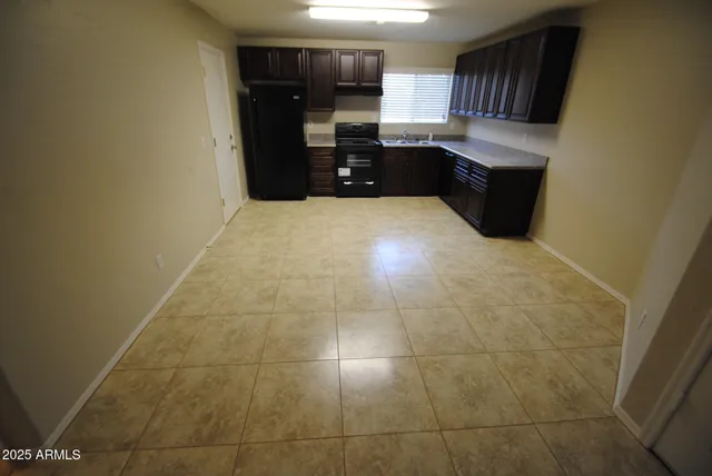 a kitchen with granite countertop a rug and a wooden floor