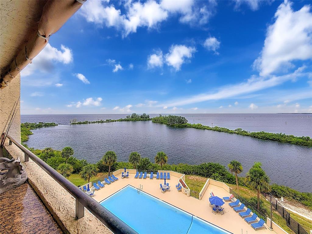 a view of a lake with couches chairs