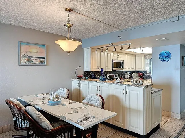 a balcony with a table and chairs