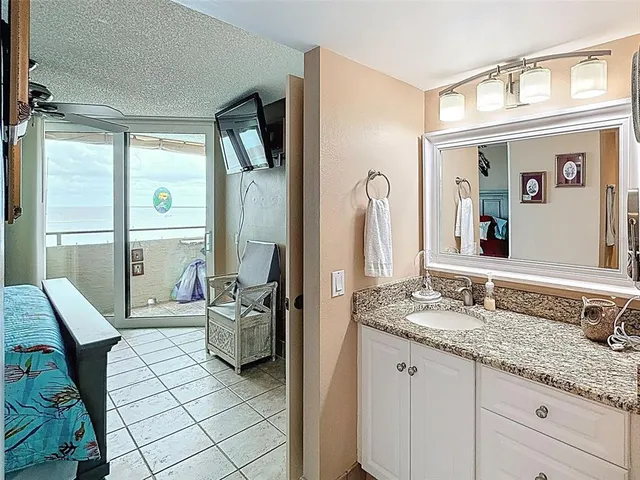 a front view of a building with garden and street view