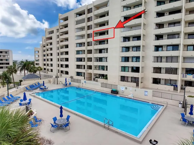 a view of a yard with a fountain and a palm tree