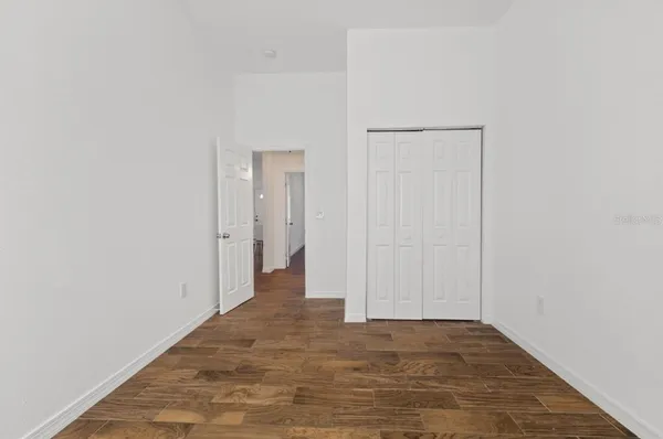 a view of a hallway with wooden floor