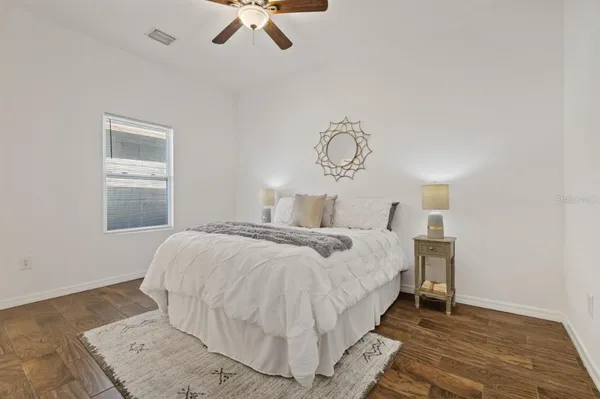 a bedroom with a bed and a chandelier