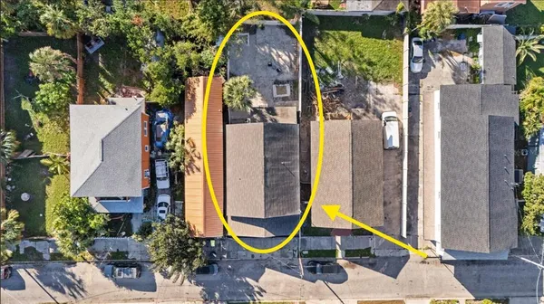 an aerial view of a swimming pool with outdoor seating
