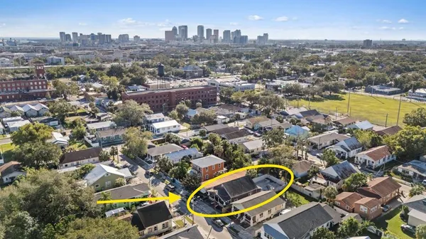 an aerial view of residential houses with outdoor space and swimming pool