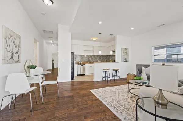 a living room with furniture and kitchen view