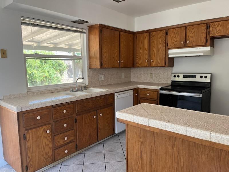 a kitchen with a cabinets and window