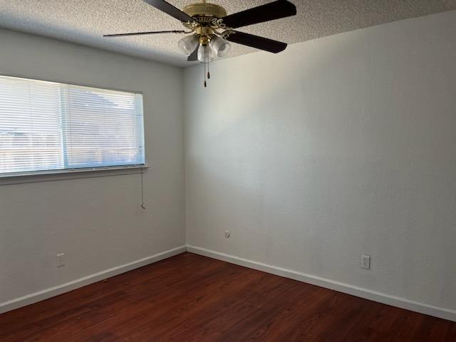 3065 Anderson Avenue Clovis, CA 93612 - Photo 11 of 16 an empty room with wooden floor fan and windows