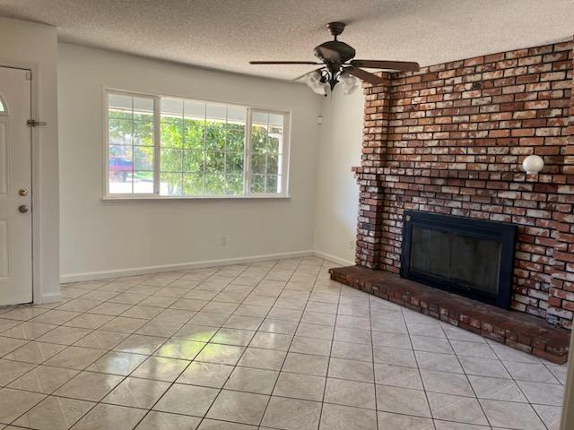 3065 Anderson Avenue Clovis, CA 93612 - Photo 6 of 16 a view of an empty room with a fireplace and a window