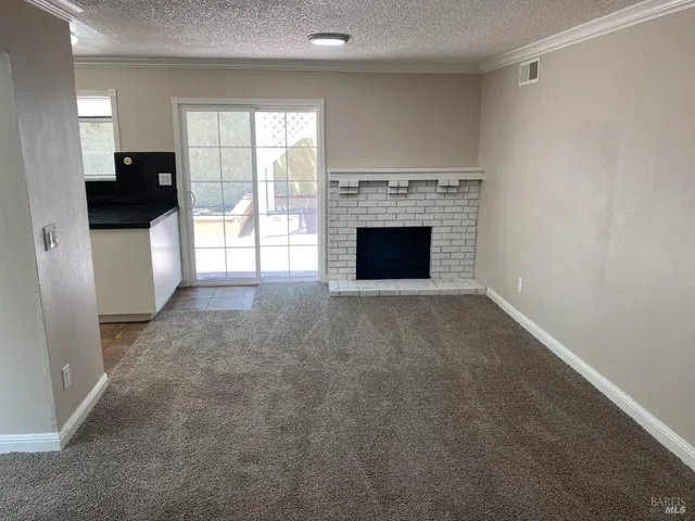 a view of empty room with a fireplace