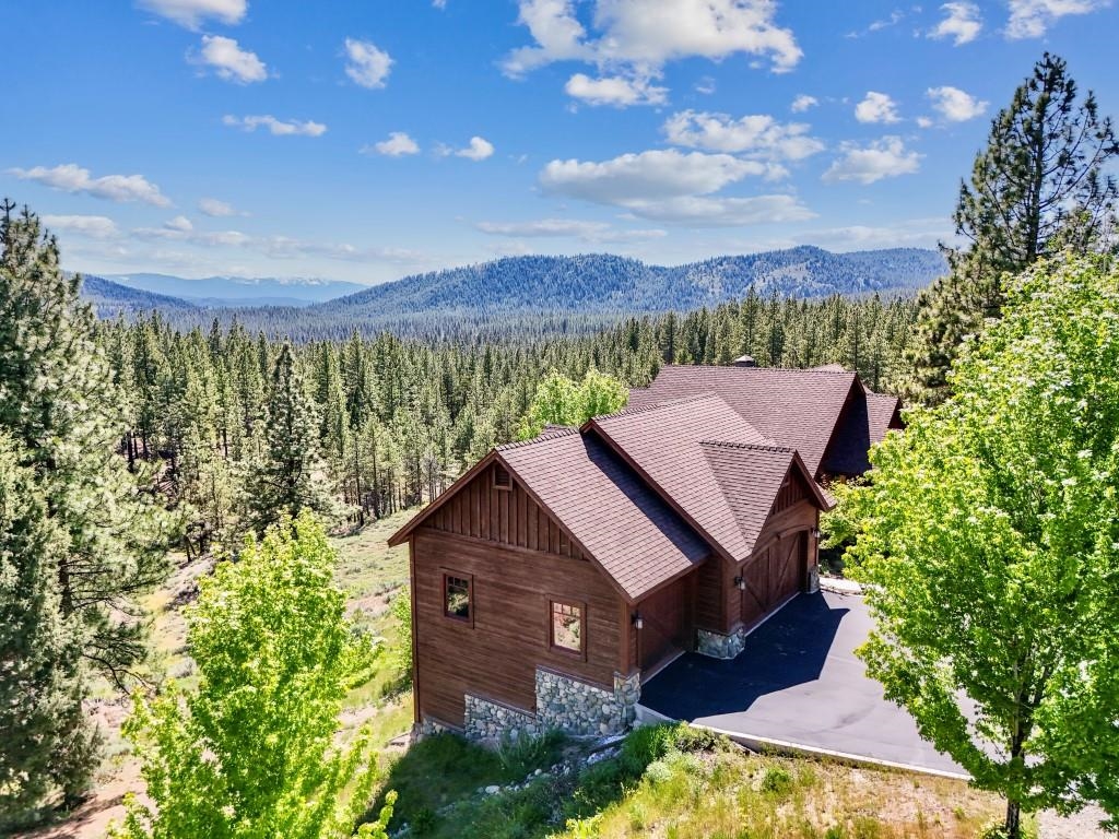 1947 Grizzly Ranch Road Portola, CA 96122 - Photo 1 of 25 a view of a house with a yard and a large tree
