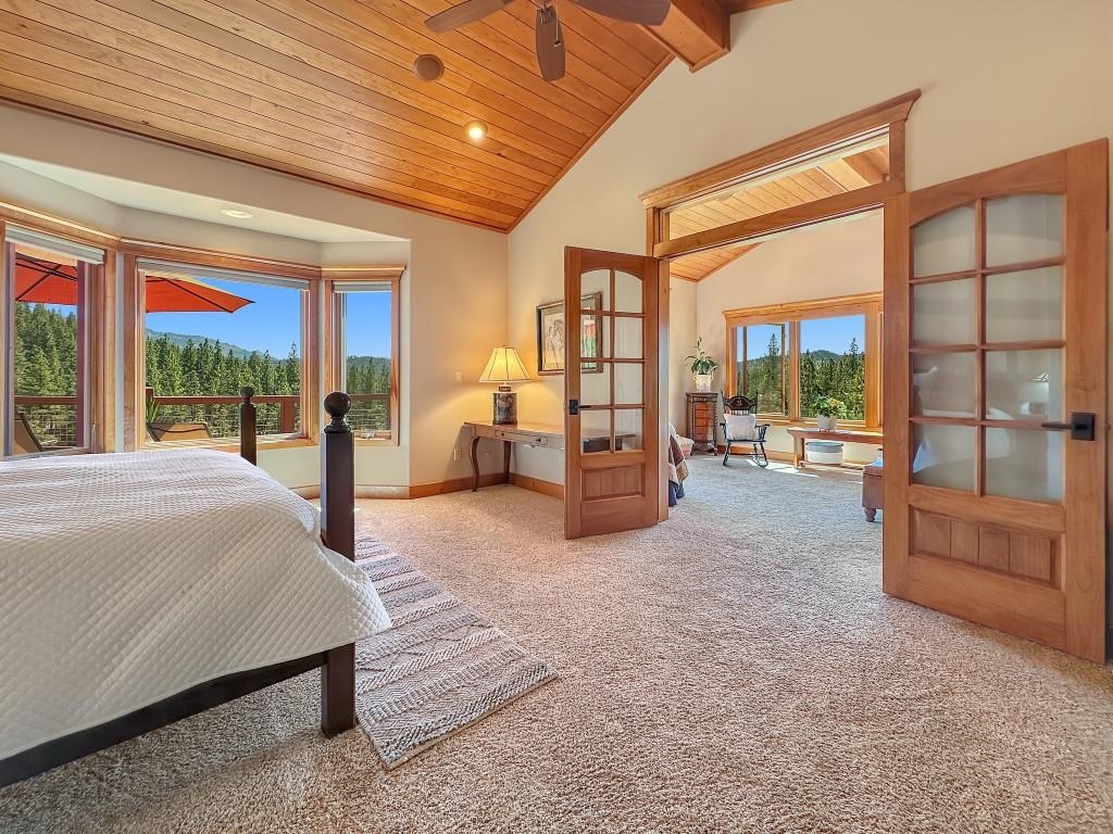 1947 Grizzly Ranch Road Portola, CA 96122 - Photo 11 of 25 a spacious bedroom with a large bed and large windows