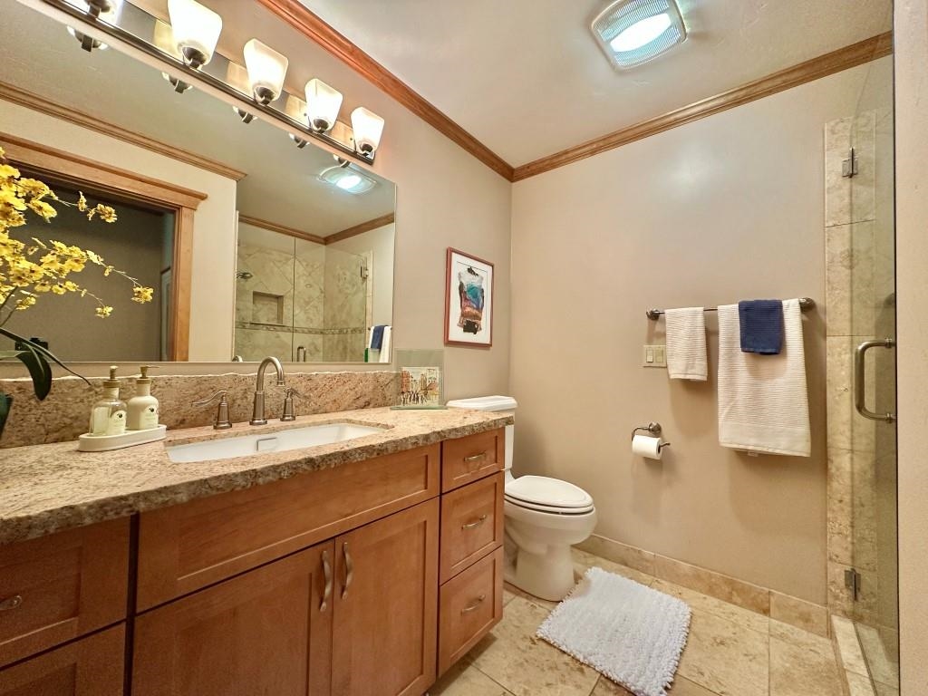 1947 Grizzly Ranch Road Portola, CA 96122 - Photo 19 of 25 a bathroom with a granite countertop sink a toilet and a mirror