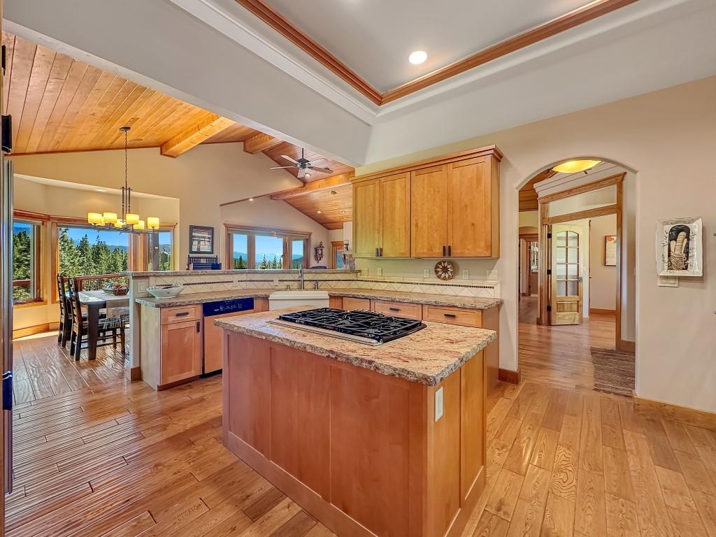 1947 Grizzly Ranch Road Portola, CA 96122 - Photo 8 of 25 a kitchen with stainless steel appliances granite countertop a stove and a wooden cabinets