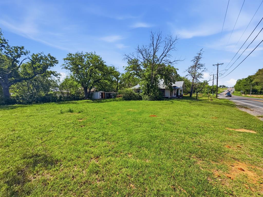 908 South Rice Street Hamilton, TX 76531 - Photo 4 of 13 a view of a garden with a building in the background