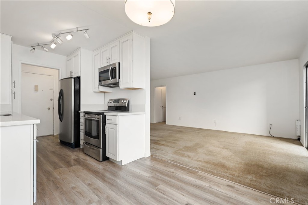 12200 Montecito Road, Unit D301 Seal Beach, CA 90740 - Photo 6 of 28 a kitchen with a refrigerator and a stove top oven
