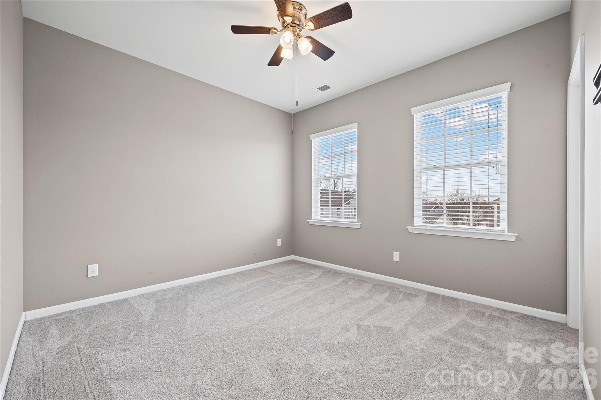 6179 Cloverdale Drive Fort Mill, SC 29708 - Photo 22 of 39 an empty room with windows and fan